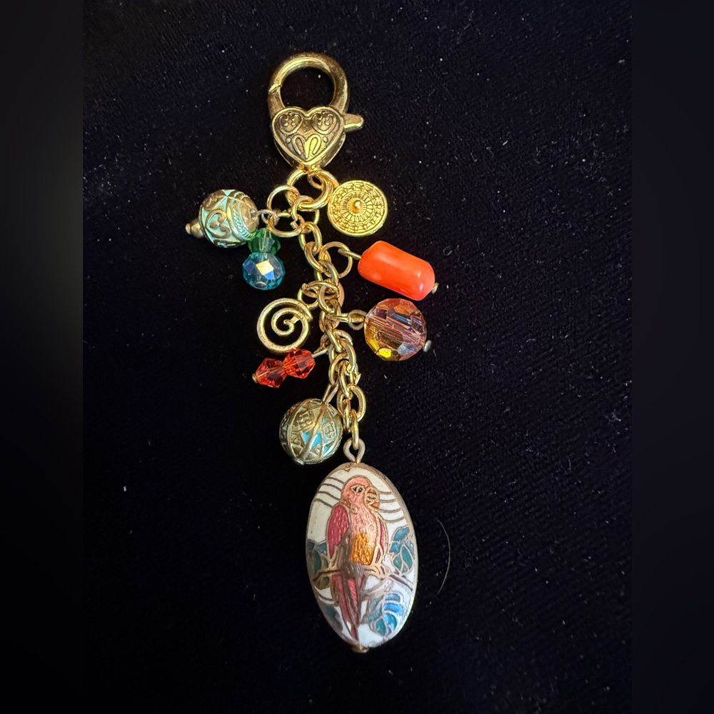 Gold colored Parrot bag charm hangs 3 inches